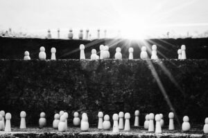 set of figurines on steps representing social ladder