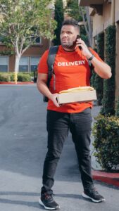 a deliveryman carrying a package feeling confused and lost